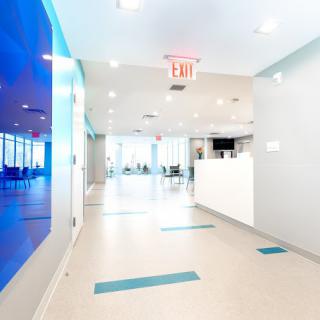 A bright and modern hospital hallway with a reception area.