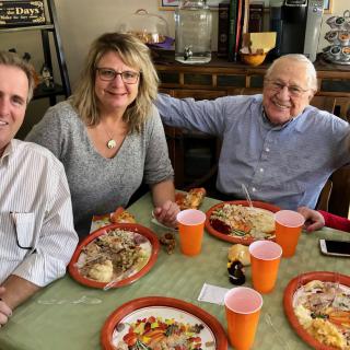 A group of people enjoying a meal together at a table.