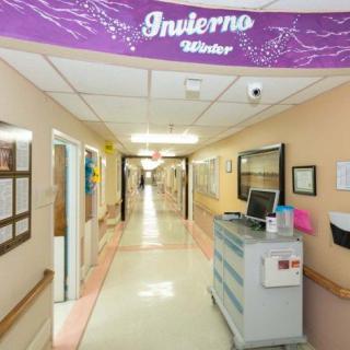 A decorated hospital hallway with a 'Invierno/Winter' banner.