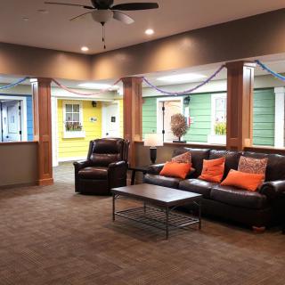 A modern living room with colorful walls, comfortable seating, and stylish decor.
