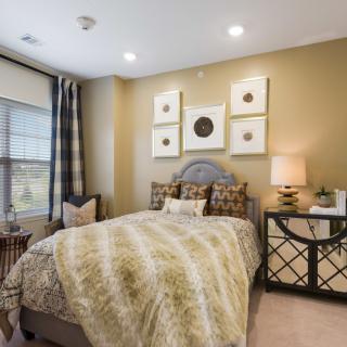 A modern bedroom with stylish decor and soft lighting.