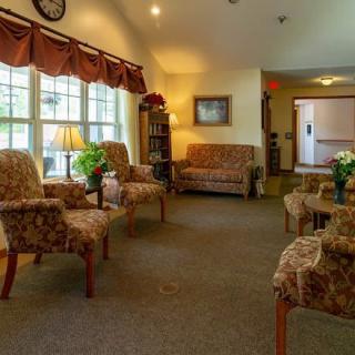 A cozy and well-lit living room with comfortable seating arrangements.