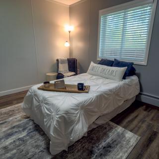 A cozy, modern bedroom with stylish decor and a comfortable bed.
