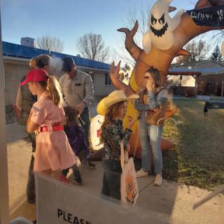 A lively Halloween scene with children in costumes enjoying the festivities.