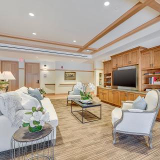 A modern living room featuring comfortable seating and elegant wood accents.