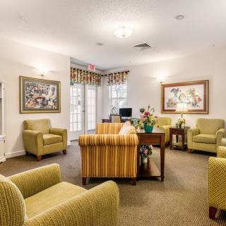 A cozy living room with comfortable seating and decorative artwork on the walls.