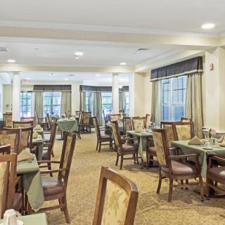 An elegant dining room with neatly arranged tables and chairs, ready for guests.