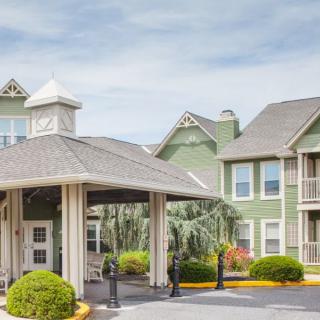 A well-maintained hotel entrance with manicured landscaping.