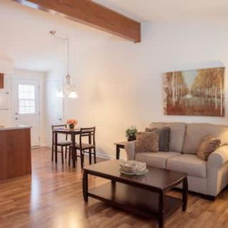 A cozy living and dining area with modern furniture and warm lighting.