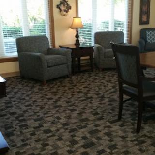 A cozy living room setup featuring comfortable chairs and a warm lamp.