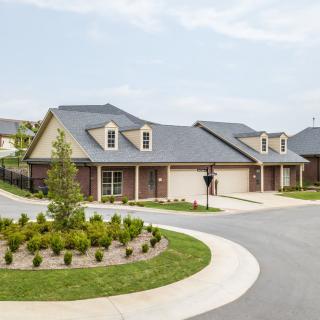 A quiet suburban neighborhood featuring well-maintained duplex houses with landscaped yards.