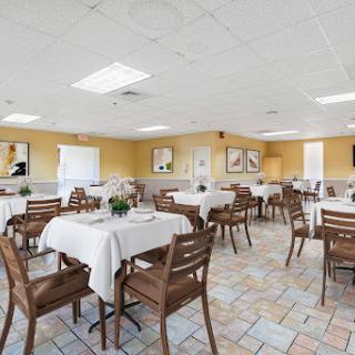A spacious and inviting dining area featuring neatly arranged tables and chairs, perfect for casual meals.
