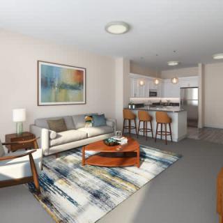 A modern open-concept living room with a stylish kitchen island and vibrant artwork.