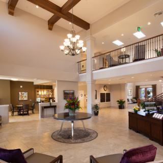 Spacious and elegantly designed lobby with modern decor and a prominent chandelier.