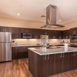 A modern kitchen with stainless steel appliances and a spacious island.