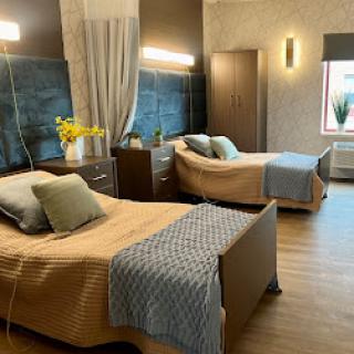 A well-designed hospital room featuring two comfortable patient beds, combining modern aesthetics with functionality.