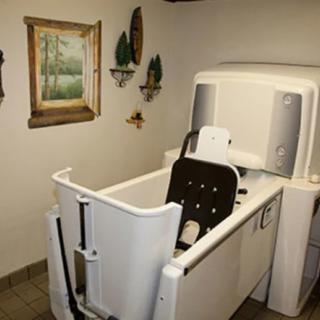 An accessible bathtub designed for easy entry and mobility support in a bathroom setting.