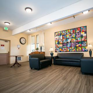 A cozy lounge area featuring comfortable seating and vibrant artwork.
