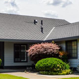 A well-maintained suburban house with a landscaped front yard.