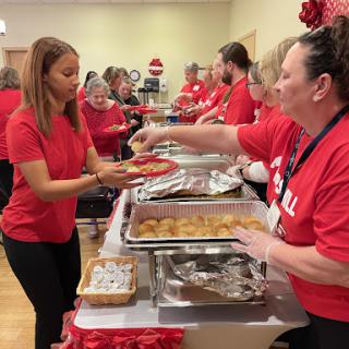 Volunteers serving food at a community holiday event.