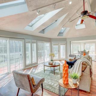 A sunlit living room featuring modern decor and ample skylights, creating a bright and inviting space.