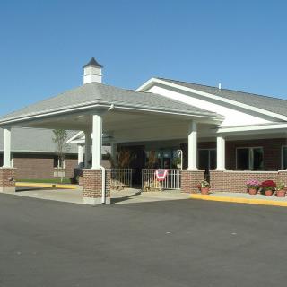 Entrance of a healthcare facility with a covered driveway.