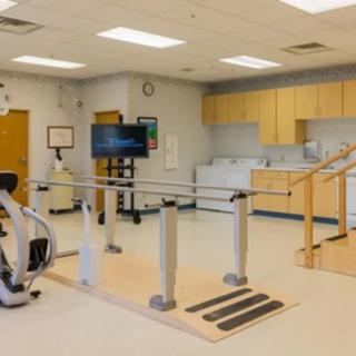 A well-equipped rehabilitation room with various exercise and therapy equipment.