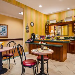A cozy cafe with a coffee station and seating area.