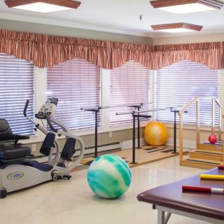 A well-equipped physical therapy room with various exercise equipment.