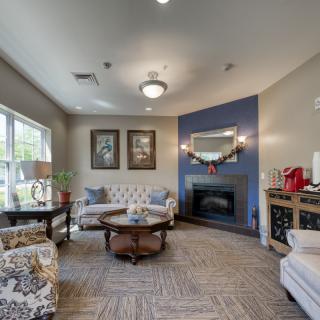 A cozy living room with elegant furnishings and a fireplace.