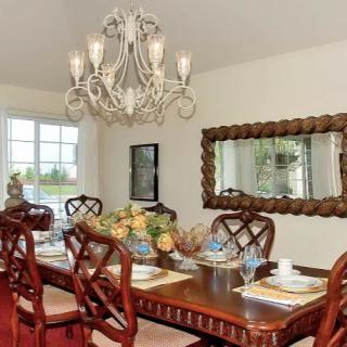 Elegant dining room with a chandelier and classic wooden furniture.