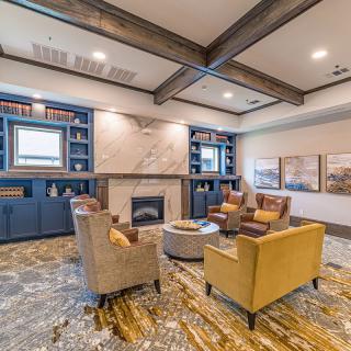 A cozy living room featuring a fireplace, comfortable seating, and modern decor.