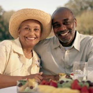 A happy couple enjoying a picnic outdoors.