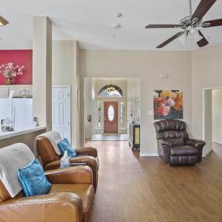A spacious living room with comfortable seating and natural lighting.