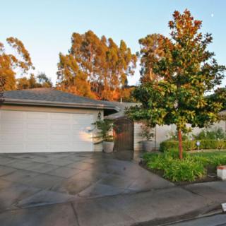 A suburban house with a two-car garage and landscaped front yard.