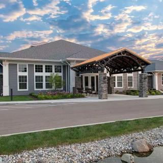 A modern residential building with a welcoming entrance and landscaped surroundings.