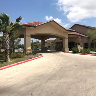 A welcoming entrance to a well-designed building set against a bright blue sky.