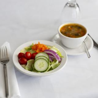 A healthy lunch featuring a fresh salad and vegetable soup.