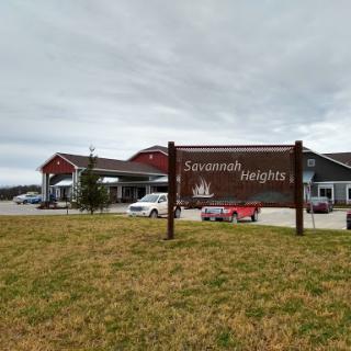 Exterior view of a residential facility with a sign indicating its name.