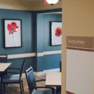 A cozy room with seating and floral artwork, labeled for activities.