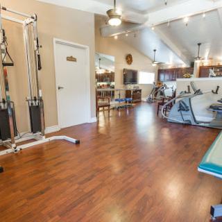 A spacious and well-equipped gym area designed for fitness and rehabilitation activities.