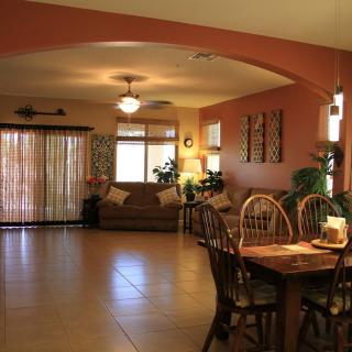 A cozy living and dining space with wooden furniture, warm lighting, and tasteful decor.