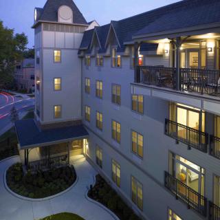 An illuminated hotel exterior during the evening, showcasing its architectural design.