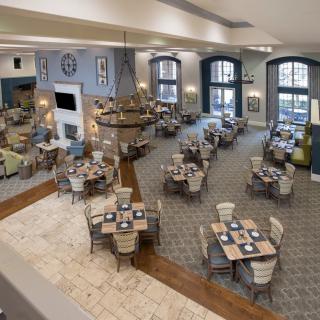 A spacious and elegantly decorated dining area with neatly arranged tables and chairs.
