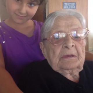 A child and an elderly person spending time together indoors.