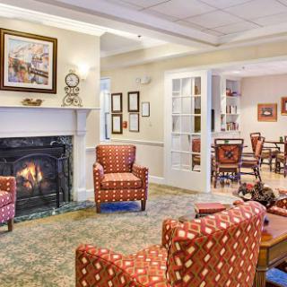 A cozy living room setting featuring comfortable armchairs and a warm fireplace.