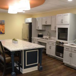 A modern kitchen featuring an island with seating, sleek cabinets, and contemporary appliances.