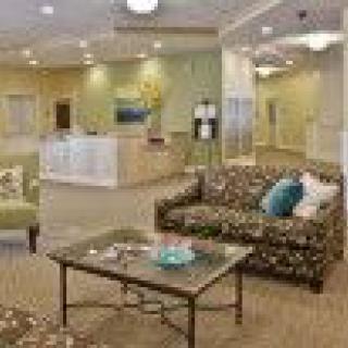 A cozy lobby with comfortable seating and a reception desk.