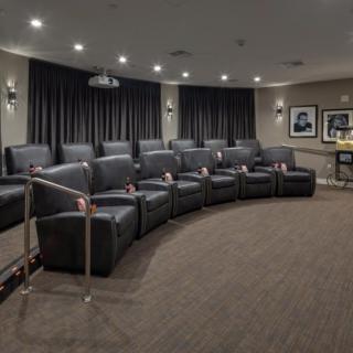 A luxury home theater with comfortable recliner seating and elegant decor.