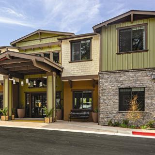 Modern residential building with a stone facade and welcoming entrance.
